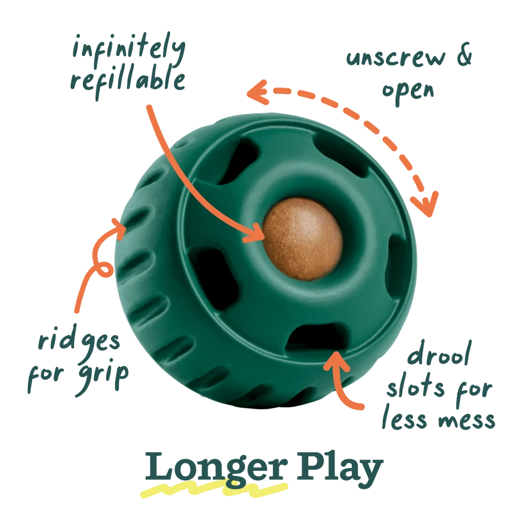Green round dog toy with textured ring, holes, and a center ball for chewing